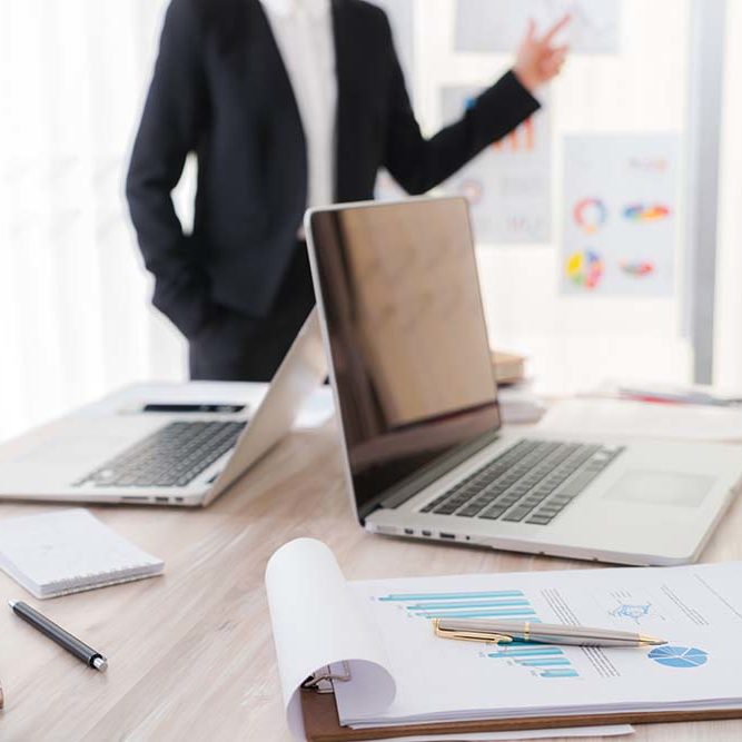 Business people using laptop  and Financial charts  at meeting office